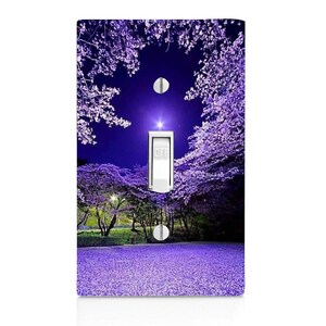 May include: A light switch cover with a photograph of a purple flower field at night. The image shows a field of purple flowers under a dark blue sky with a bright star in the center. The switch is labeled "OFF".