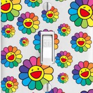 May include: A white light switch cover with a repeating pattern of colorful smiling flower designs. The flowers are multi-colored with a yellow center and a smiling face.