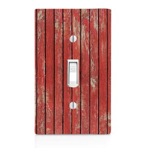 May include: Red wooden light switch cover with a weathered, distressed look. The cover has a light switch with the word "OFF" printed on it.