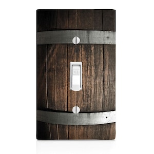 May include: A light switch cover with a wood grain design that looks like a wooden barrel. The switch is labeled "OFF".