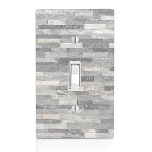 May include: A light switch cover with a gray stone pattern. The switch is labeled "OFF".