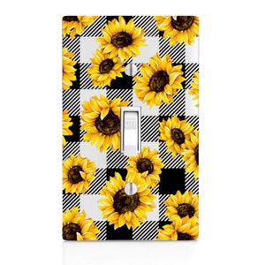 May include: A white light switch cover with a black and white checkered pattern and a sunflower design. The switch is labeled "OFF".