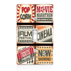 May include: A set of six vintage-style light switch covers featuring movie-themed designs. The covers feature images of popcorn, a movie marathon, a film festival, a cinema, tickets, and a film reel with the text "Now Showing".
