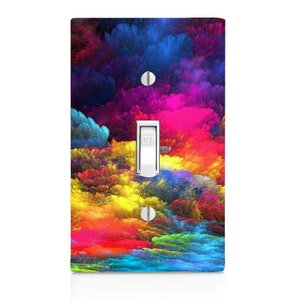 May include: A light switch cover with a colorful abstract design featuring vibrant hues of blue, purple, pink, yellow, orange, and red. The design resembles a swirling cloud of paint.