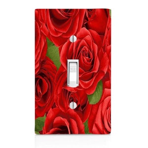May include: A light switch cover with a red rose floral pattern. The switch is labeled "OFF".