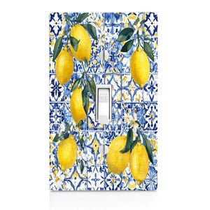 May include: A decorative light switch cover featuring a watercolor design of lemons and leaves against a blue and white tile pattern. The switch is white and has an "OFF" indicator.