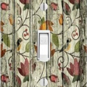 May include: A light switch cover with a floral pattern on a wood background. The pattern features red, green, and yellow flowers with brown vines. The switch cover has a white toggle switch with the word "OFF" printed on it.
