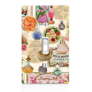 May include: A vintage-style light switch cover featuring a collage of perfume bottles, flowers, and text in various colors, including pink, blue, green, and yellow. The text includes the words "Rose de Provence", "Violettes de Nice", and "Solon Palmer Perfumes".
