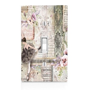 May include: A light switch cover with a vintage design featuring a ballerina, swans, musical notes, and floral accents. The switch cover has an "OFF" label on the switch.