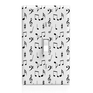 May include: White light switch cover with a black and white musical note pattern. The switch is labeled "OFF".