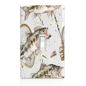 May include: A rectangular light switch wall plate featuring a watercolor-style pattern of largemouth bass fish, fishing nets, and fishing rods on a light gray background. The white toggle switch in the center has the word OFF printed on it.