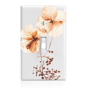 May include: A light switch cover with a floral design featuring dried hydrangeas in shades of brown and beige. The switch is labeled "OFF".