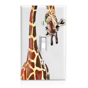 May include: White light switch cover featuring a watercolor giraffe design. The giraffe's head and neck are depicted, with the word "OFF" visible on the switch. The giraffe has brown and tan spots.