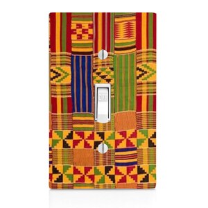 May include: A light switch cover with a colorful African print design. The print features a patchwork of yellow, red, green, and blue geometric patterns.