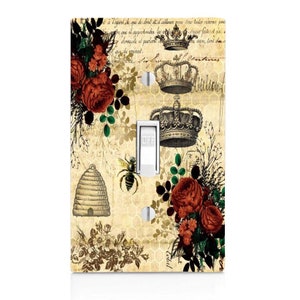 May include: A light switch cover with a vintage design featuring a bee, honeycomb, roses, and crowns. The background is a faded beige with a honeycomb pattern. The text "OFF" is visible on the switch.
