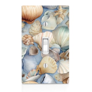 May include: A light blue background with a variety of seashells in shades of white, brown, and beige. The shells are arranged in a random pattern and some are overlapping. The word "OFF" is visible on a white light switch.