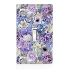 May include: A light switch cover with a floral pattern featuring purple, white, and blue flowers. The switch is labeled "OFF".