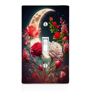 May include: A light switch cover with a crescent moon and red, white, and pink roses on a dark blue background with stars. The switch is labeled "OFF".