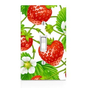 May include: White light switch cover with a red and green strawberry pattern. The switch is labeled "OFF".