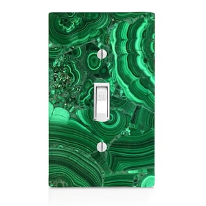 May include: Green and black malachite patterned light switch cover with a white toggle switch labeled "OFF".