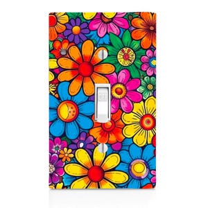 May include: A rectangular light switch cover plate featuring a vibrant, multi-colored floral pattern with overlapping daisy-like flowers in shades of orange, yellow, pink, blue, green, and purple. A white toggle switch is centered on the plate.