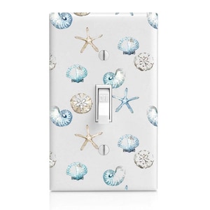 May include: A light gray single-pole light switch cover featuring a watercolor pattern of seashells and starfish in shades of blue and tan. The switch is white, with the word "OFF" printed on it.