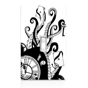 May include: Black and white light switch cover featuring an octopus with a clock, playing cards, and a key. The switch is labeled "OFF".