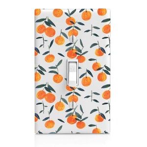 May include: A white light switch cover featuring a repeating pattern of watercolor oranges with green leaves and stems. The switch is white with the word "OFF" printed on it. The cover has two silver screws.