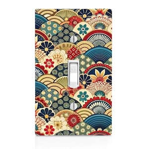 May include: A rectangular light switch wall plate featuring a repeating pattern of overlapping semicircular fan shapes in shades of navy blue, red, teal, and gold. The design includes floral motifs and small dots. A white toggle switch is in the center.