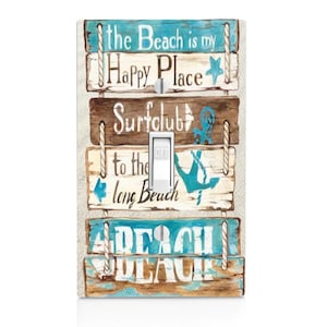 May include: A decorative light switch cover with a beach theme. The design features wooden planks with beach-related phrases and images in blue and white. The switch is in the off position.