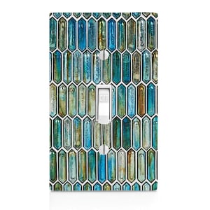May include: A decorative light switch cover with a mosaic tile design in shades of blue, teal, and gold. The switch is white and in the "off" position. The cover has a glossy finish.