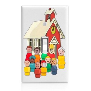 May include: A white rectangular light switch cover plate featuring a colorful illustration of a red schoolhouse with a bell tower and a group of eleven small, stylized peg-style figures in various bright clothing colors standing in front.