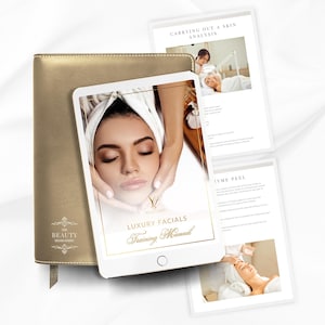 May include: A gold-colored leather-bound notebook with the text "The Beauty" and a decorative design. A white tablet displays the text "Luxury Facials Training Manual" and an image of a person receiving a facial. Two pages of text are visible.