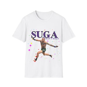 May include: White t-shirt with a colorful paint splatter design. The shirt features a graphic of a man in mid-air with the text "SUGA SEAN O'MALLEY".