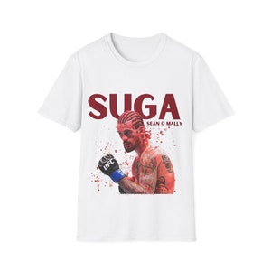 May include: White t-shirt with a red graphic of a man with a red mohawk and the text "SUGA SEAN O'MALLY".