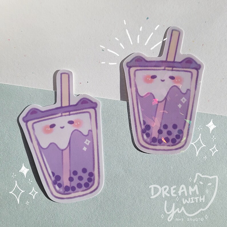 May include: Two purple and white bubble tea stickers with cute cartoon faces and a straw. The stickers have a holographic finish and are decorated with white stars.