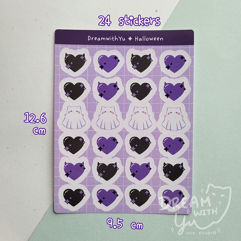 May include: A sheet of 24 Halloween themed stickers featuring purple and black hearts, ghosts, and devil horns. The sheet measures 9.5 inches by 12.6 inches.