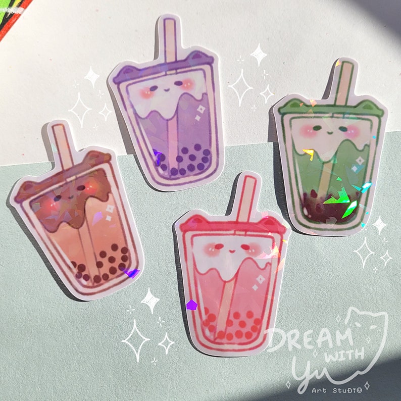 May include: Four colourful holographic stickers of cartoon bubble tea cups with cute faces and straws. The stickers are on a light blue background with white stars.