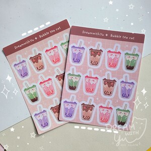 May include: Two sheets of stickers featuring a cartoon cat drinking bubble tea. The stickers are pink with white outlines and feature different coloured bubble tea cups. The text "DreamwithYu Bubble tea cat" is printed on each sheet.