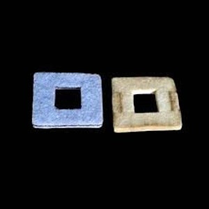 May include: Two square, textured coasters. One is light blue, the other is beige. Each has a square cutout in the center. The coasters are displayed against a black background.