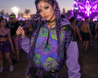 May include: A purple quarter-zip hooded jacket featuring a vibrant geometric pattern in shades of green, blue, and purple on the front panel, with solid purple sleeves and a hood, designed with elastic cuffs and a drawstring hem detail.