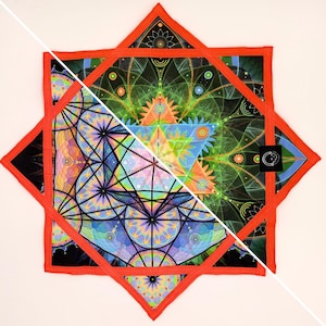 May include: A colorful, geometric design on a square fabric, featuring intricate patterns in shades of blue, green, orange, and purple. The design is framed by a red border, creating a striking visual contrast. A small black tag with a white logo is visible.
