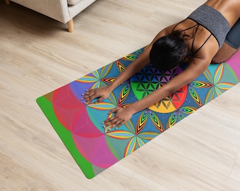 May include: A rectangular yoga mat featuring a vibrant, multi-colored geometric flower of life pattern with overlapping circles in shades of blue, green, red, yellow, and pink. The mat displays a complex, symmetrical design with radiating petals.