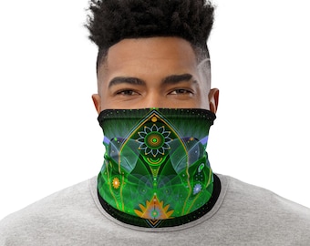 May include: A tubular neck gaiter featuring a vibrant green and black geometric pattern with symmetrical floral motifs, radiating lines, and small orange and blue accents. The design includes intricate circular and diamond shapes.