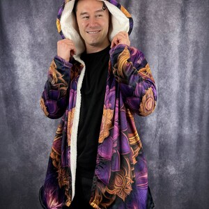 May include: A purple and gold hooded jacket with a floral pattern. The jacket has a sherpa lining and a long, flowing design.