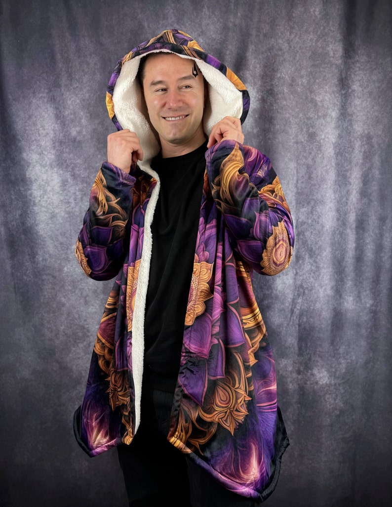 May include: A purple and gold hooded jacket with a floral pattern. The jacket has a sherpa lining and a long, flowing design.