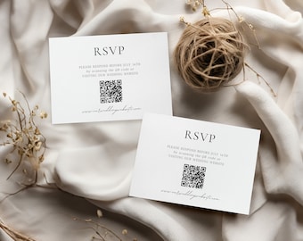 May include: Two white RSVP cards with black text and QR codes, set against a neutral fabric background. A ball of twine and dried flowers are also present. The cards read "RSVP" and provide instructions.