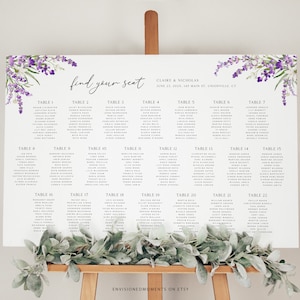 May include: A white seating chart with lavender floral accents and the text "find your seat." The chart lists names under numbered tables. The event details include the names Claire & Nicholas and the date and location.