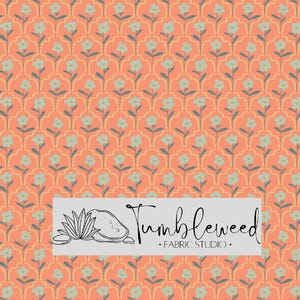 May include: Coral-colored fabric with a repeating floral pattern in light blue and yellow. The design features stylized flowers and leaves. The fabric has the text "Tumbleweed Fabric Studio" in a rectangular white box.