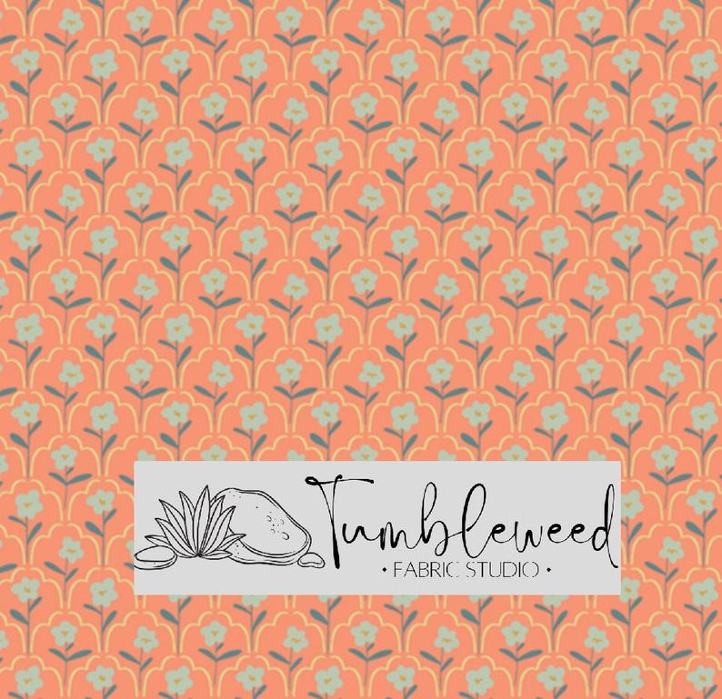 May include: Coral-colored fabric with a repeating floral pattern in light blue and yellow. The design features stylized flowers and leaves. The fabric has the text "Tumbleweed Fabric Studio" in a rectangular white box.